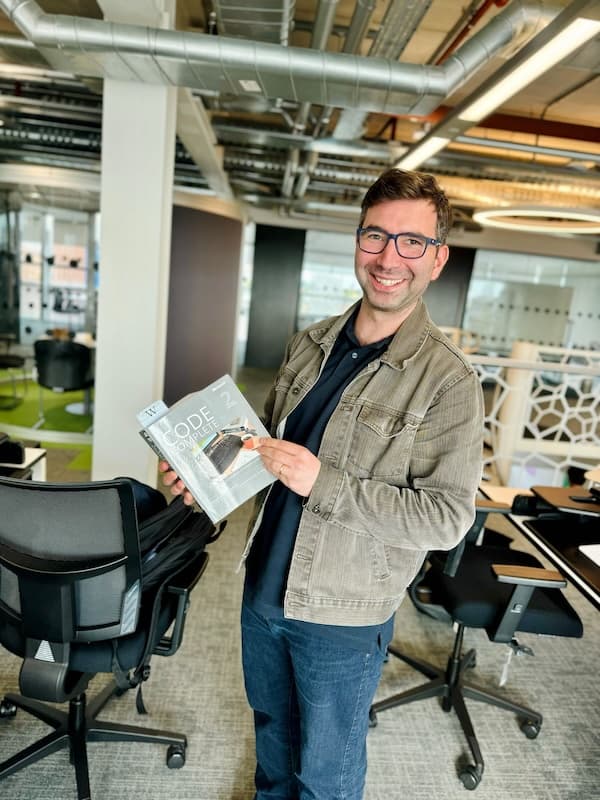 Me holding a copy of Code Complete 2 and looking quite chuffed with myself.